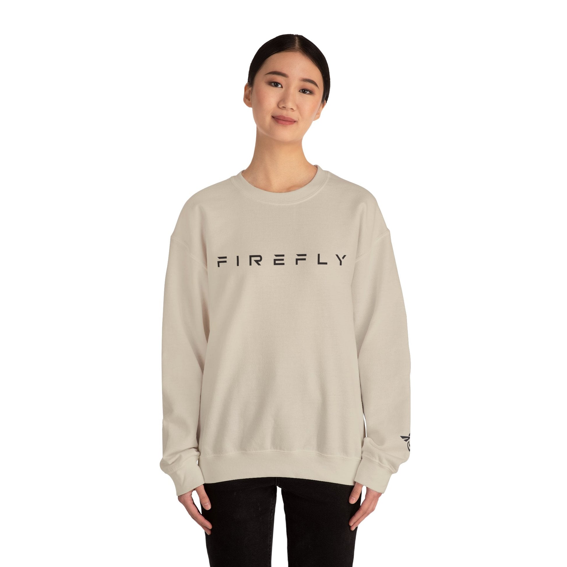 Person wearing a beige sweatshirt with a small graphic on a white background