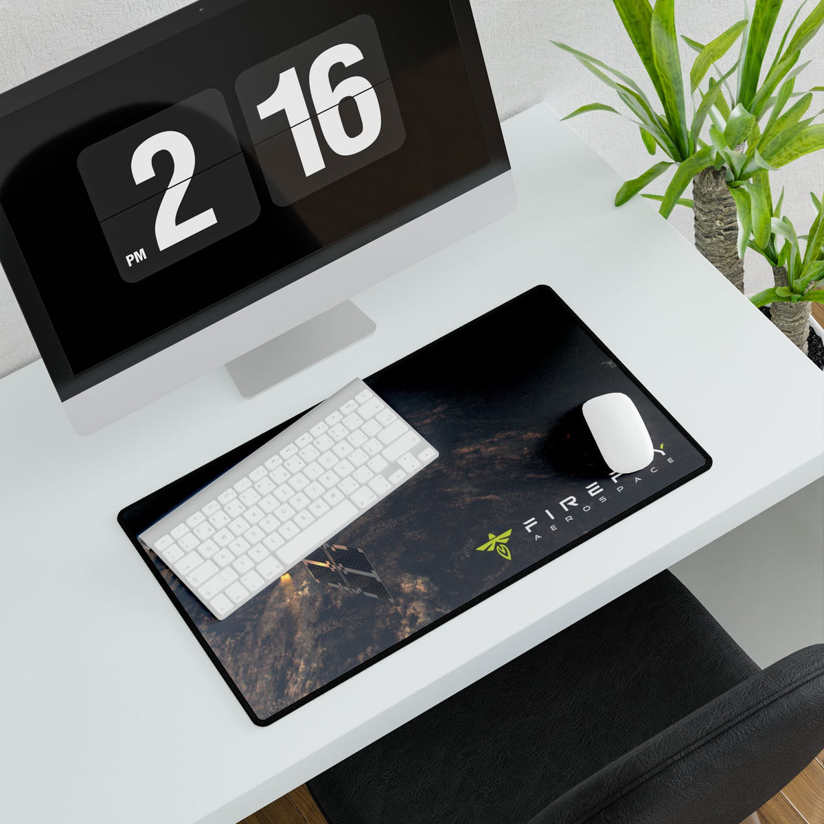 Desk setup with a computer, keyboard, mouse, and desk mat on a white desk.