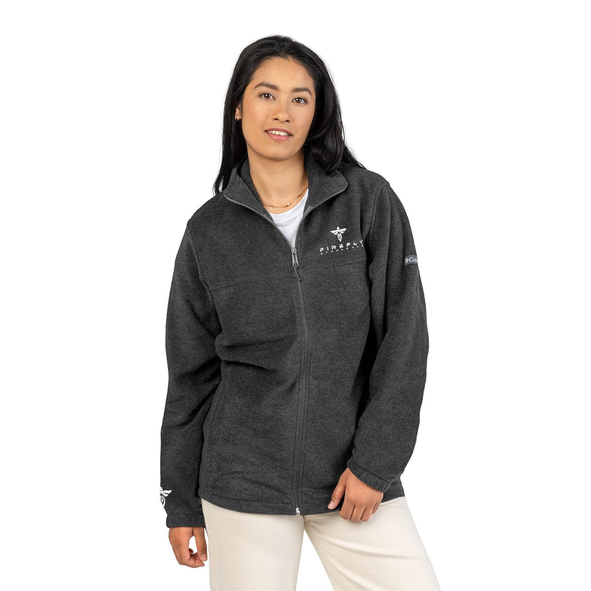 Woman wearing a dark gray fleece jacket with a logo on a white background