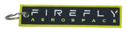 Firefly Aerospace keychain with green border and white text on a black background