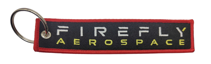 Firefly Aerospace keychain with red border on a white background