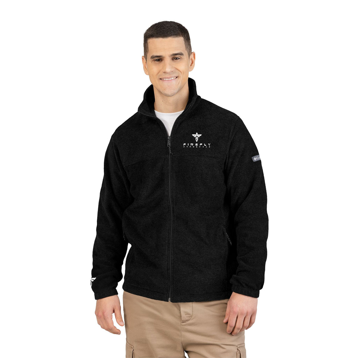 Man wearing a black jacket with logos on a white background